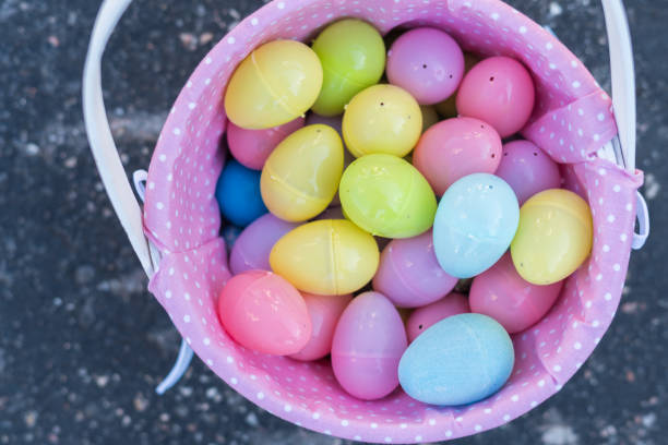 istock Easter basket filled with colorful plastic eggs from the Easter egg hunt. 1194258319
