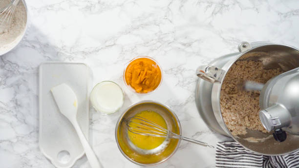 istock Mixing ingredients in electric kitchen mixer to bake pumpkin spice cupcake. 1194258355