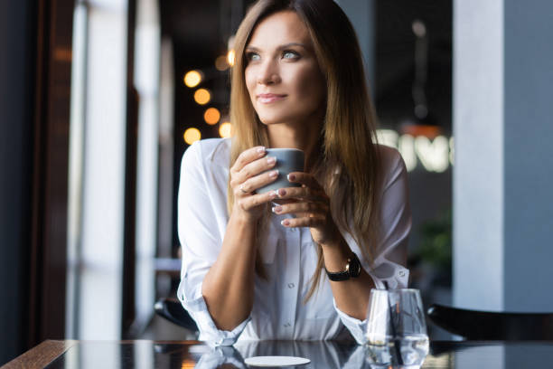istock woman drinking coffee in the morning at restaurant 1194260593