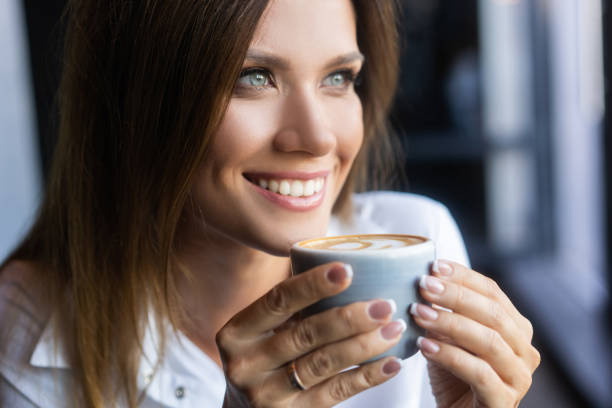 istock woman drinking coffee in the morning at restaurant 1194260596