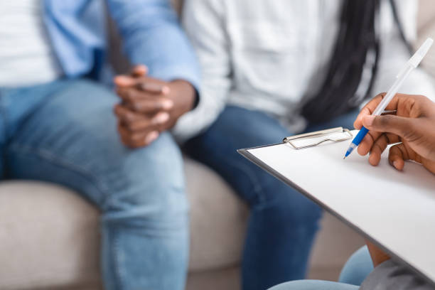 istock Marriage counselor taking notes during therapy session with black married couple 1194261614