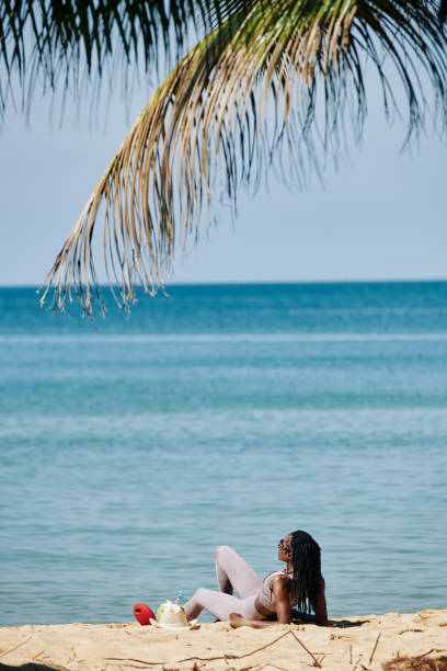 istock Sportswoman resting on beach 1194261811
