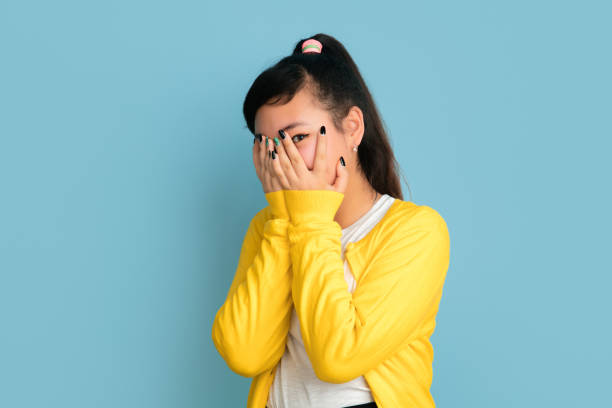 istock Asian teenager's portrait isolated on blue studio background 1194263582