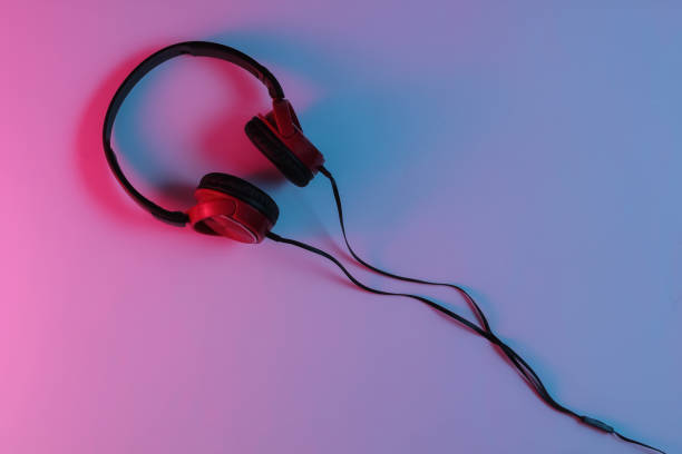 istock Wired headphone with neon blue-red gradient light. Retro wave, 80s pop culture. Top view 1194266729