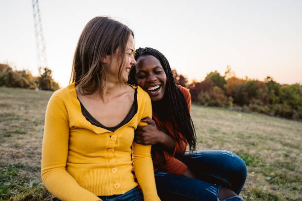 istock Multi-ethnic female friends sitting on meadow 1194266875