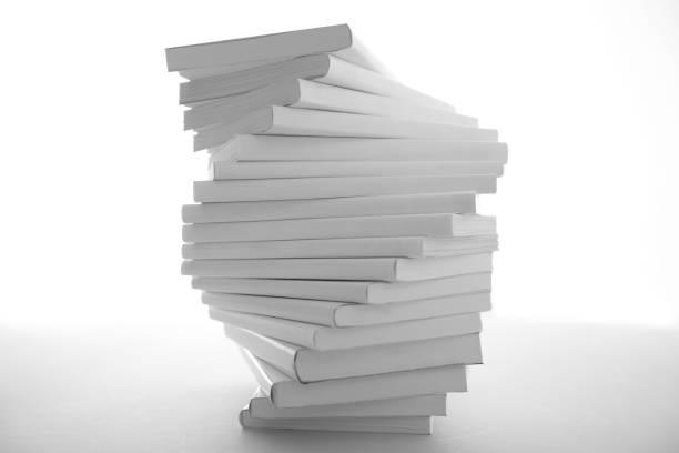 istock Stacked white books and laptop 1194267300