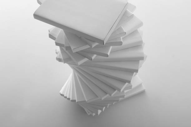 istock Stacked white books and laptop 1194267423