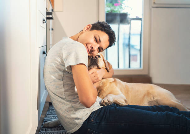 istock Teen boy playing with his dog 1194269642