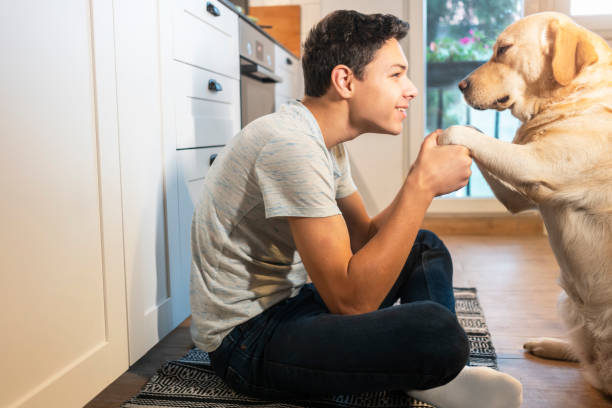 istock Teen boy playing with his dog 1194270334