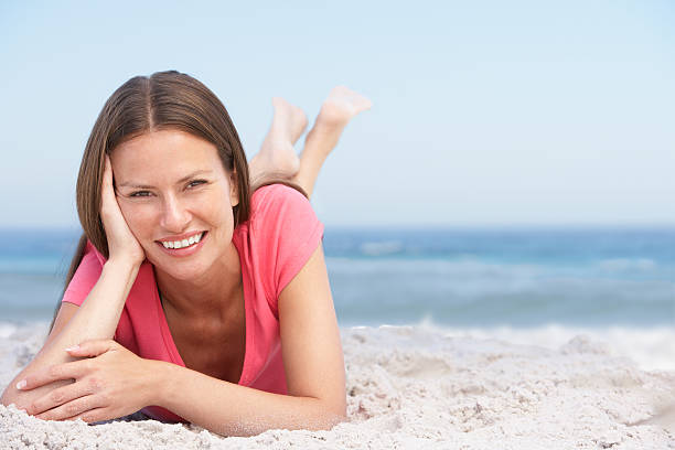 istock Young Woman Relaxing On Sandy Beach 119427076