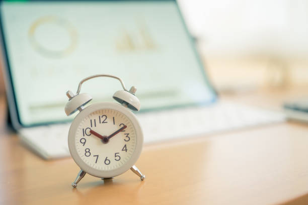 istock Vintage White Alarm Clock on on a NoteBook. It's time to rest. using as background  Relaxing time concept with copy spaces for your 1194271802