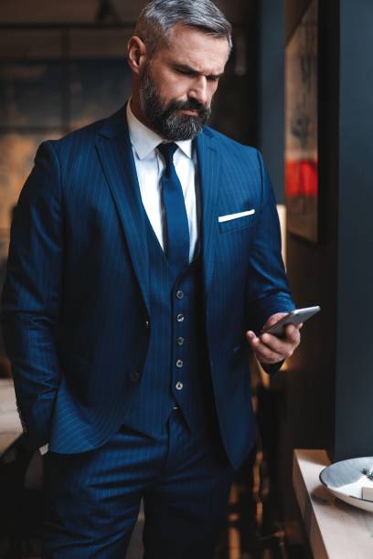 istock Formally dressed male executive manager in trendy clothes using mobile phone 1194274033