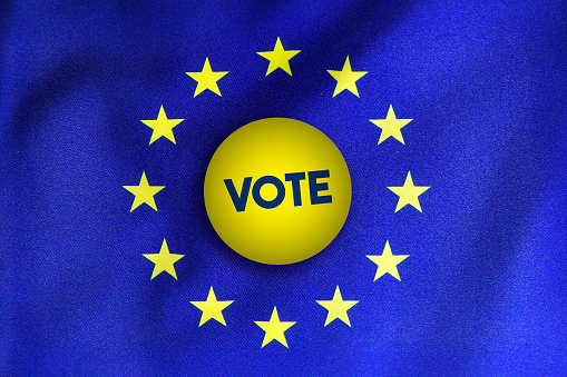 Vote Badge over European union flag. Horizontal composition with copy space.