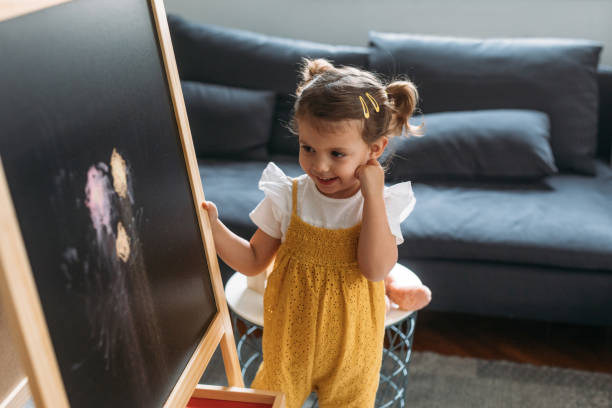 istock Child Standing by the Blackboard 1194274244