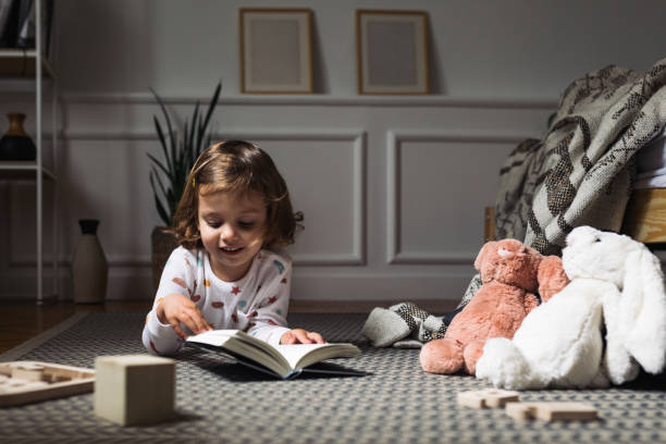 istock Little Girl Reading a Book 1194274285