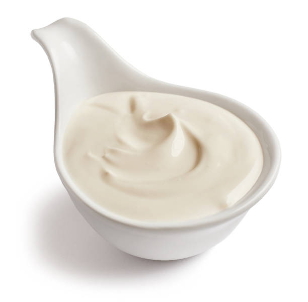 istock bowl of sour cream isolated on white background, selective focus 1194276102