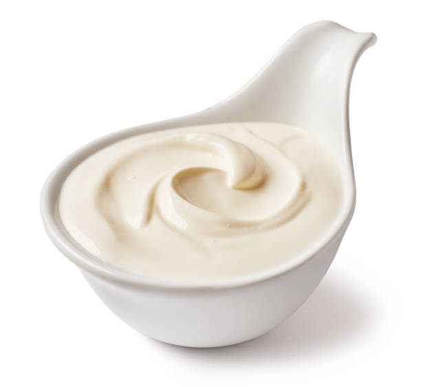 istock bowl of sour cream isolated on white background, selective focus 1194276107