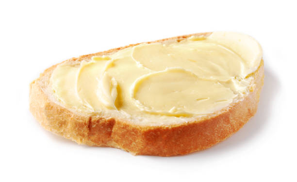 istock bread with butter isolated on white background, selective focus 1194276458