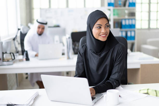 istock Arab businesswoman working in modern office, using laptop 1194281272