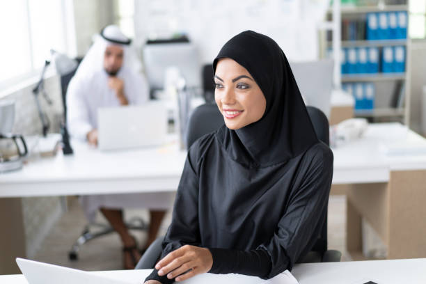 istock Arab businesswoman working in modern office, using laptop 1194281300