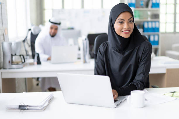istock Arab businesswoman working in modern office, using laptop 1194281568