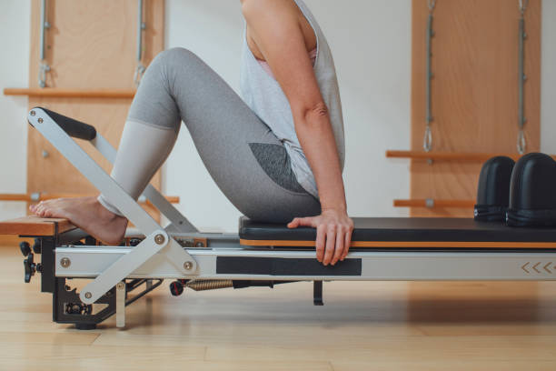 istock Sportswoman Doing Exercise on Pilates Reformer 1194282299