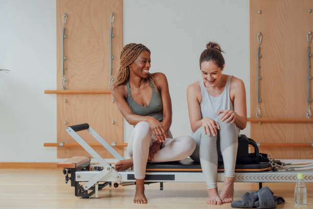 istock Girlfriends Sitting on PiIates Reformer and Chatting 1194282305