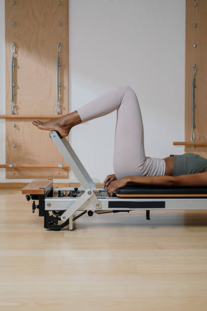 istock Sportswoman Doing Exercise on Pilates Reformer 1194282317