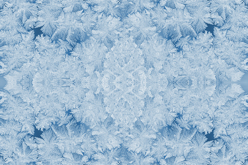 Kaleidoscope of frosty patterns in trendy 2020 Classic Blue. Collage. Christmas or New Year festive background or wallpapers.