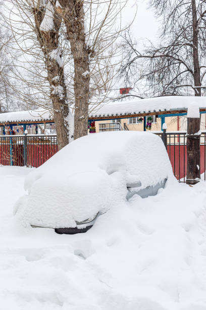 istock Entirely snowbound grey car is standing fixedly in snowdrift in yard house. 1194282856