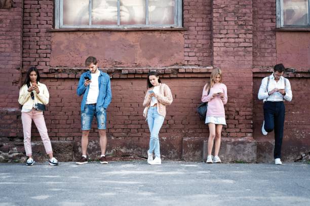 istock People standing with smartphones, reading messages, posts in social networks. 1194283047