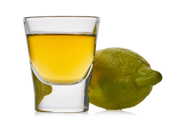 istock glass with strong alcoholic drink and lemon 1194283091