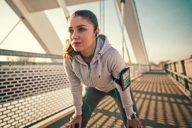 istock Young athletic woman runner on a bridge 1194284503
