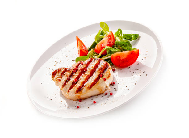 istock Barbecue pork with vegetables on white background 1194285779