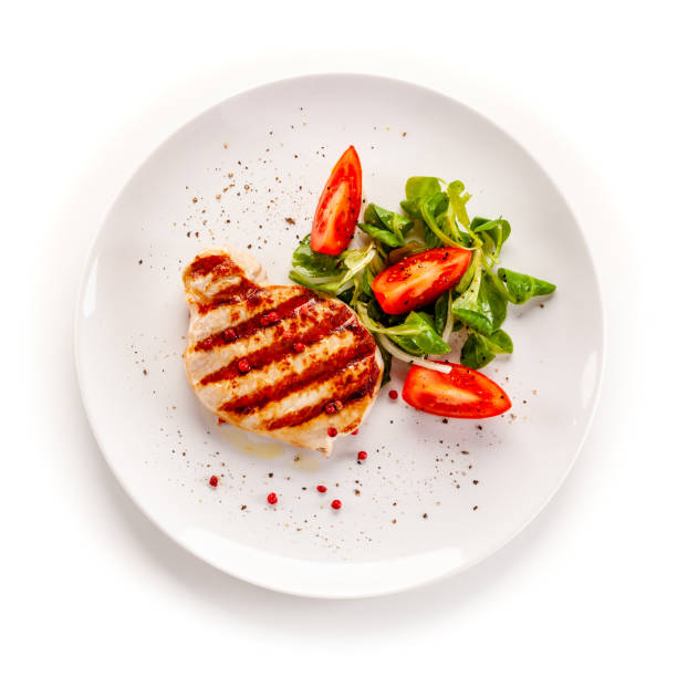 istock Barbecue pork with vegetables on white background 1194285917