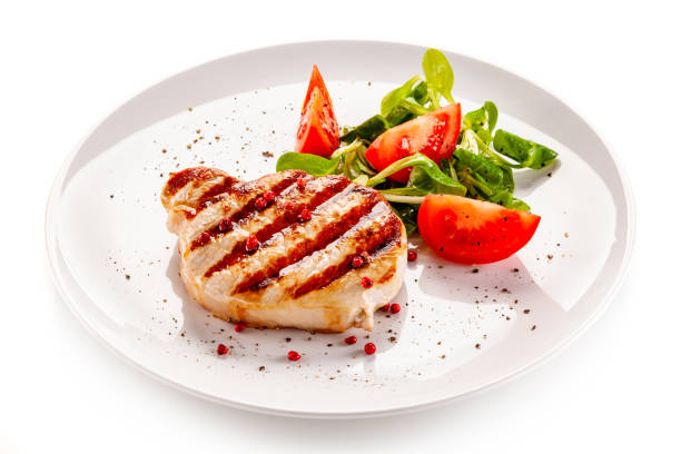 istock Barbecue pork with vegetables on white background 1194285941