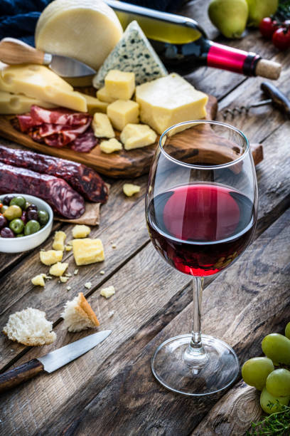 istock Appetizer: red wineglass, cheese and spanish chorizo on rustic wooden table 1194287757