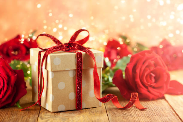 istock Gift box with red ribbon bow and red roses. 1194288767