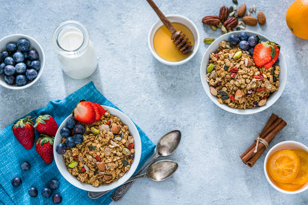 istock Healthy eating: two granola bowls with fruits for breakfast. Top view 1194290465