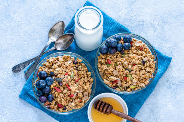 istock Healthy eating: two granola bowls with berries for breakfast. Top view. 1194291772