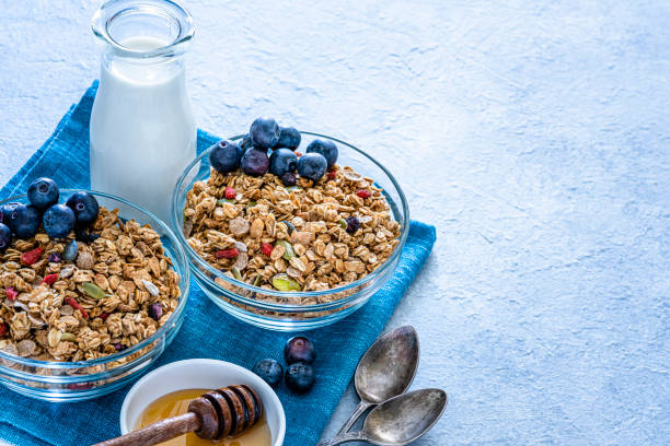 istock Healthy eating: two granola bowls with berries for breakfast. High angle view. 1194292131