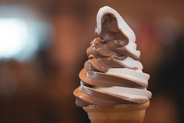 istock Hand holding a two-tone soft serve ice cream cone 1194292616