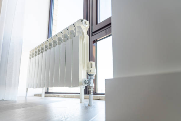 istock White big radiator near window in modern room 1194293800