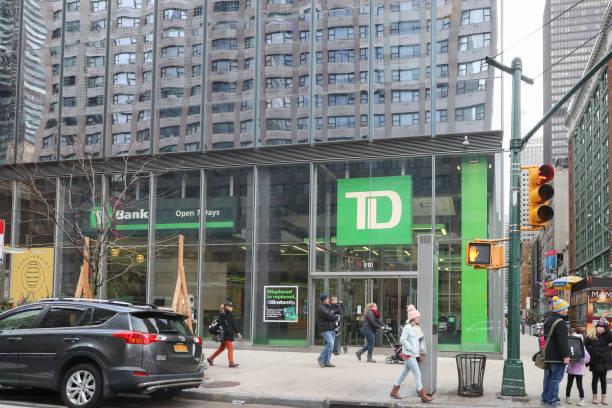 People walk by a TD Bank retail stock photo
