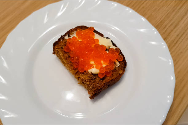 istock Sandwich with butter and red caviar on plate. 1194296320