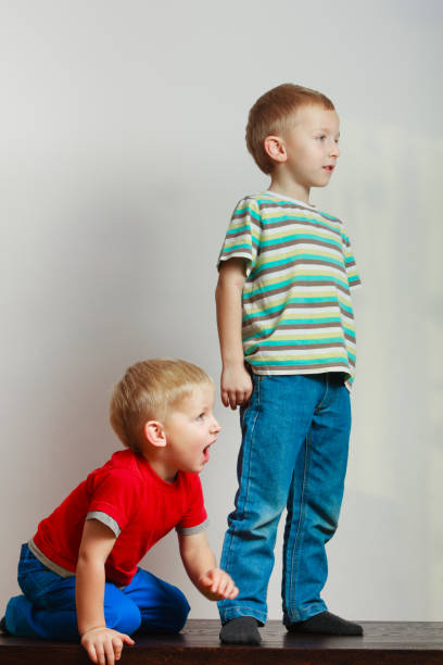 istock Two little boys siblings playing together on table 1194297384