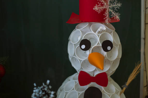 Christmas ornaments and a Snowman made out of white plastic cups and color paper