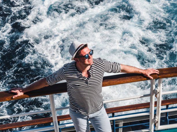 istock Smiling man on the empty deck of a liner 1194298716