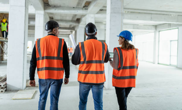 istock Investors Talking To Construction Foreman At A Construction Site 1194298805