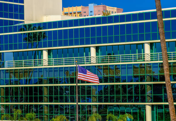 istock American Flag by Blue Glass Building 1194298834